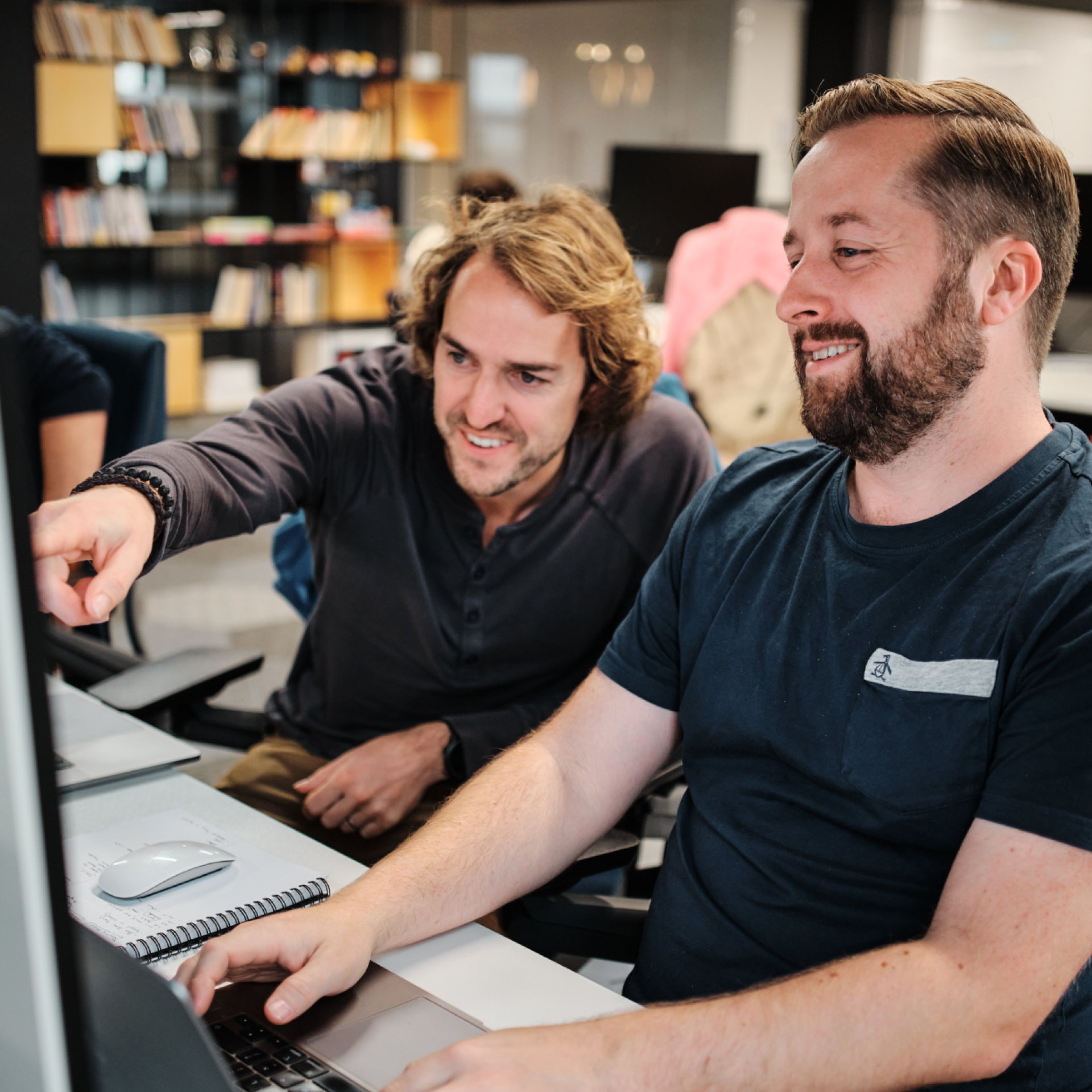 Two recruiters looking at a recruitment trends report